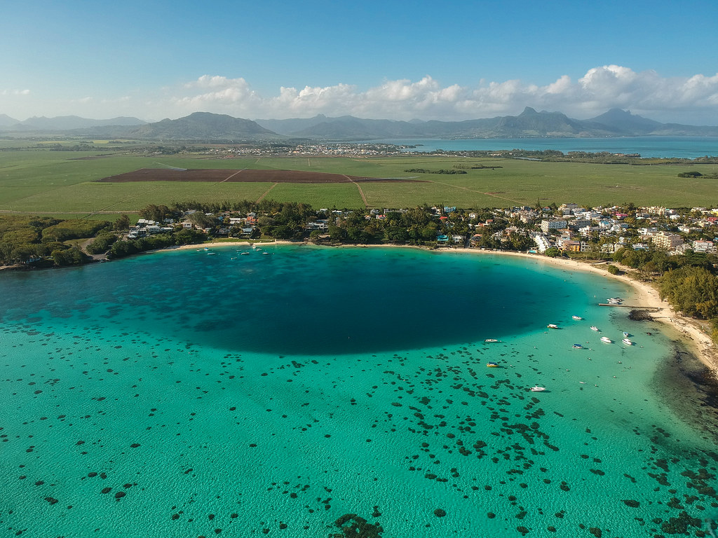 Pristine sandy Blue Bay Beach with turquoise waters during the Southeast Mauritius tour