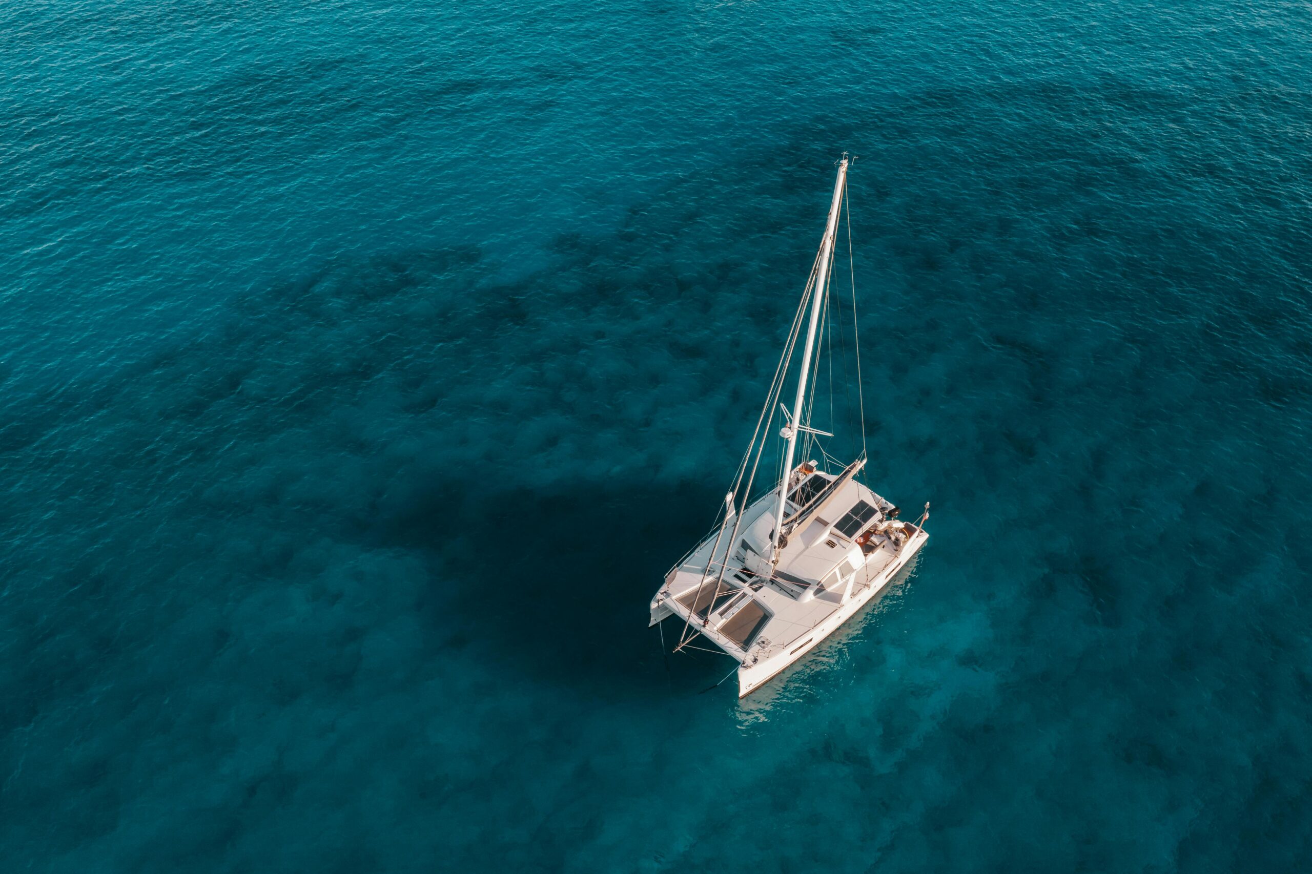 Cruise boat anchored in shallow waters next to Île aux Cocos, Rodrigues, Mauritius