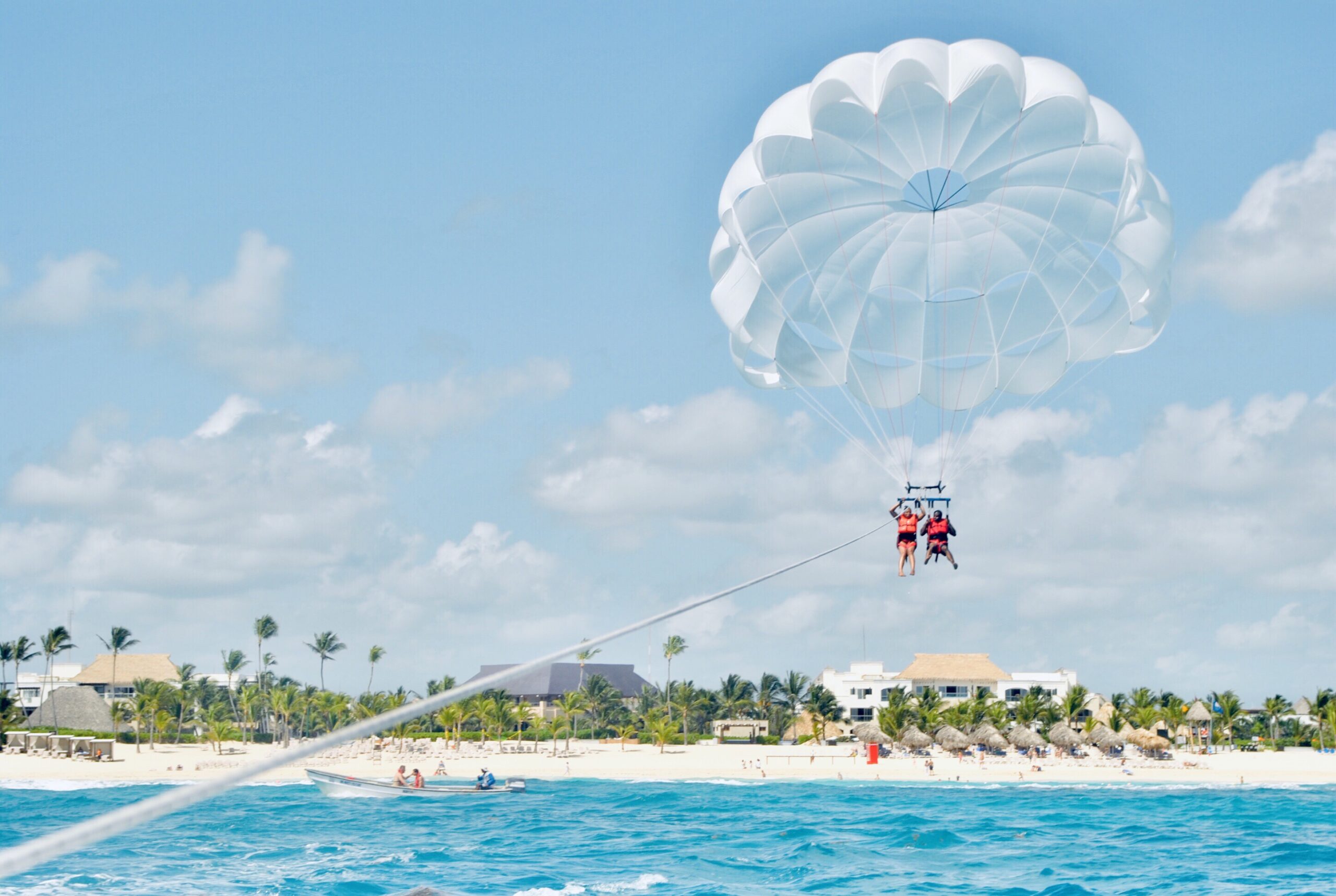 couple-parasailing-over-crystal-blue-water-in-domi-2025-01-27-09-51-34-utc