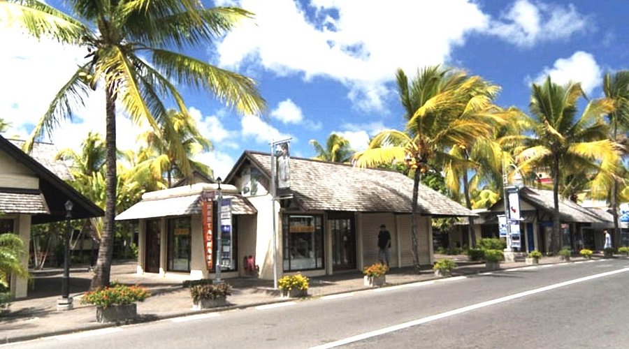 Tourists shopping and relaxing near the waterfront at Grand Bay Village in Mauritius