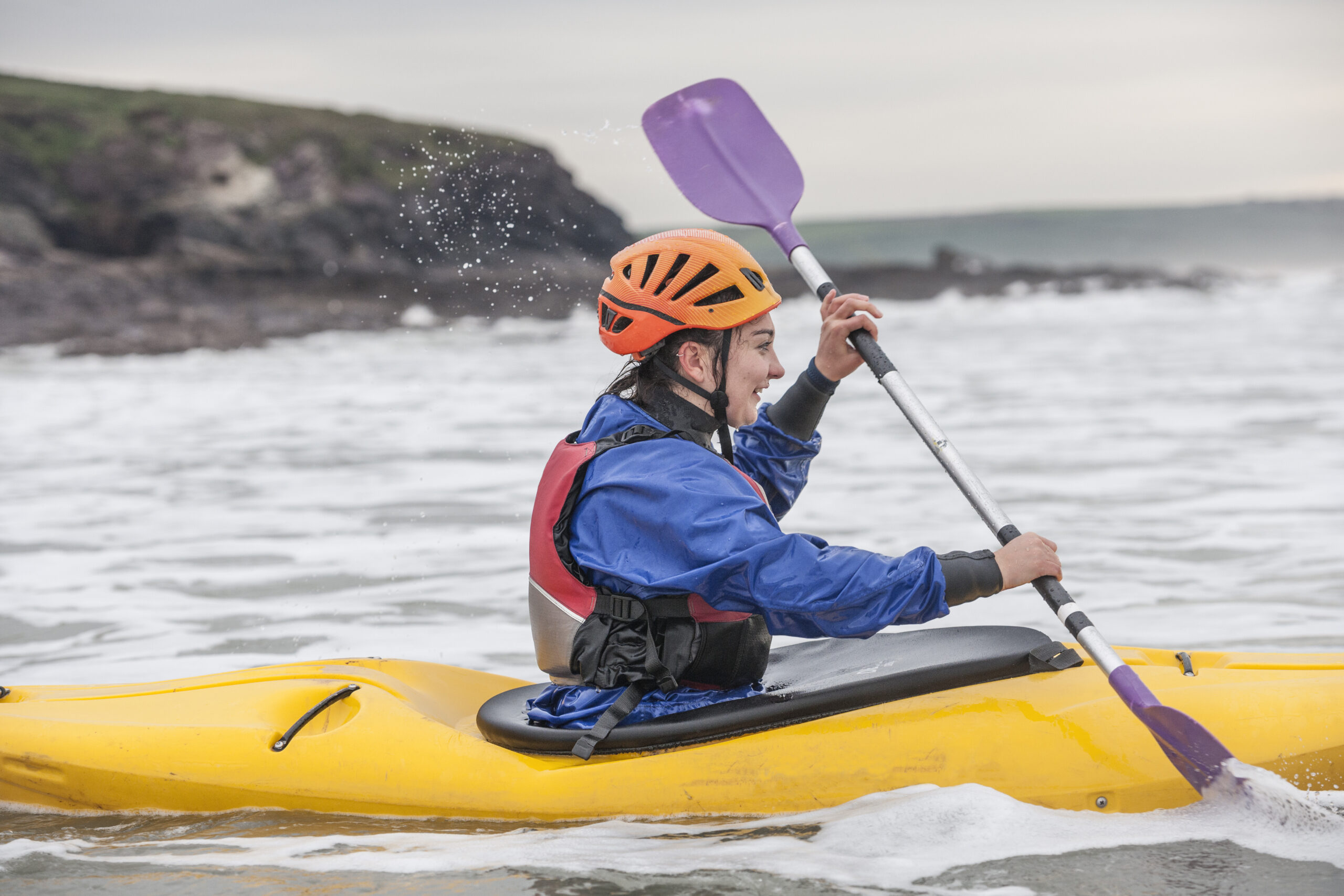 Kayaker navigating the waves with focus and determination