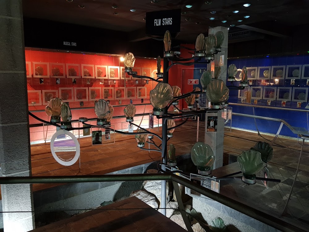 Tourist viewing handmade glass items and recycled art pieces at Mauritius Glass Gallery