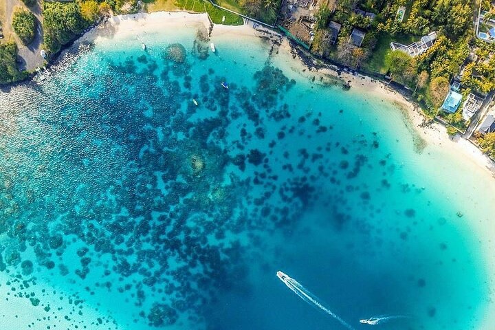 Pristine sandy Blue Bay Beach with turquoise waters during the Southeast Mauritius tour