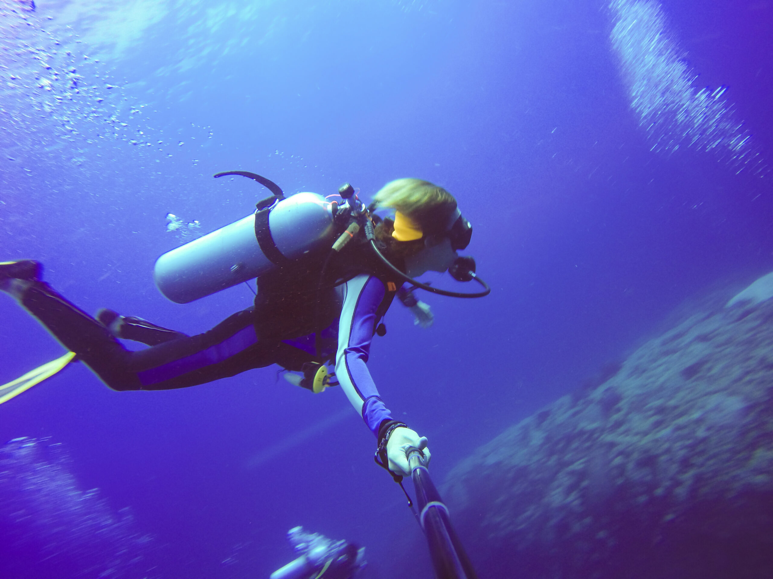 Scuba diver taking selfie underwater in Mauritius with selfie stick