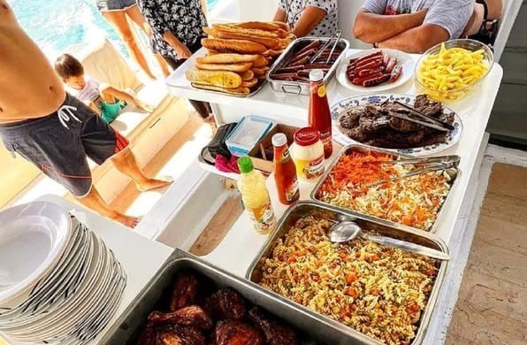 A variety of fresh food served on the boat during the Dolphin Cruise experience in Mauritius