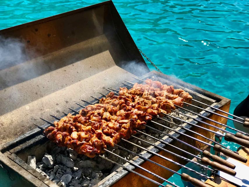 Chicken skewers being grilled for guests on the Île aux Cerfs catamaran tour