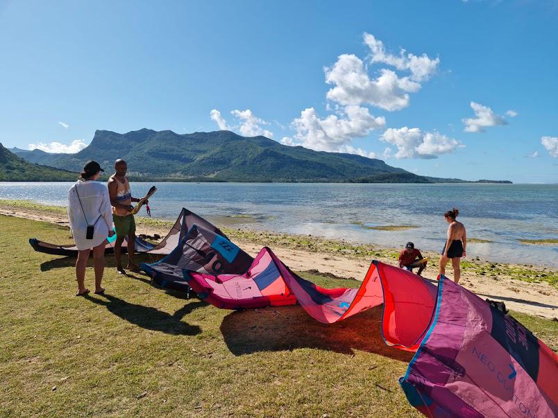 Tourists preparing kitesurfing equipment at Le Morne beach, Mauritius
