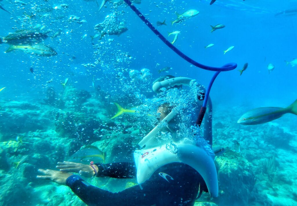 Group underwater wearing helmets during sea walk in Mauritius