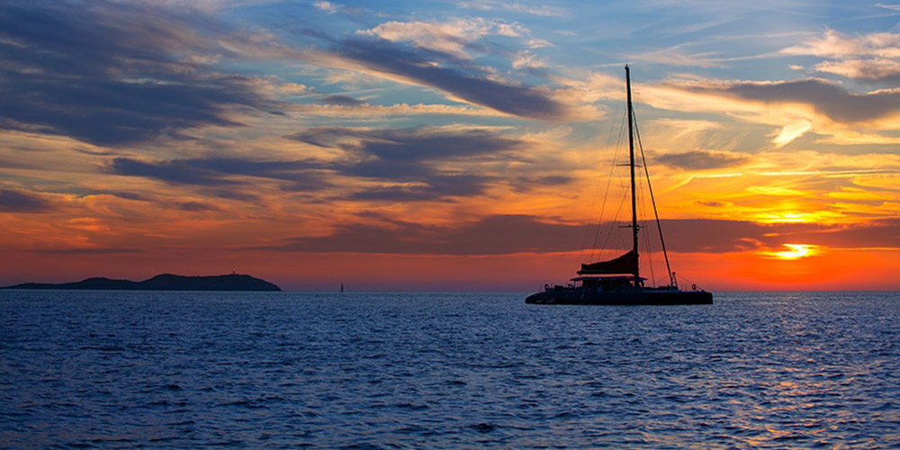 Catamaran sailing into the sunset along Mauritius’s north coast
